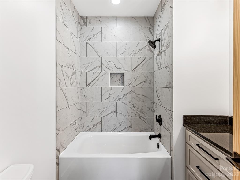 13 Small Crk Road Brevard, NC 28712 - Photo 43 of 48 a bathroom with a bathtub and a toilet