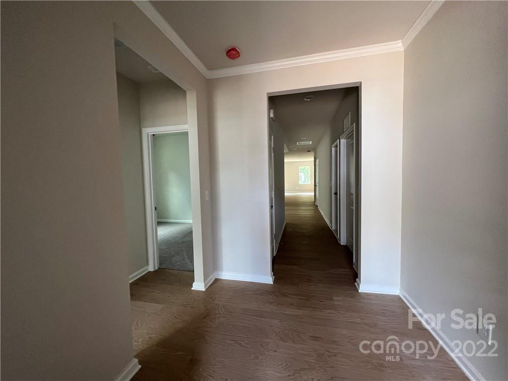 3137 Windhaven Lane, Unit 76 Tega Cay, SC 29708 - Photo 2 of 15 a view of a hallway with wooden shelves