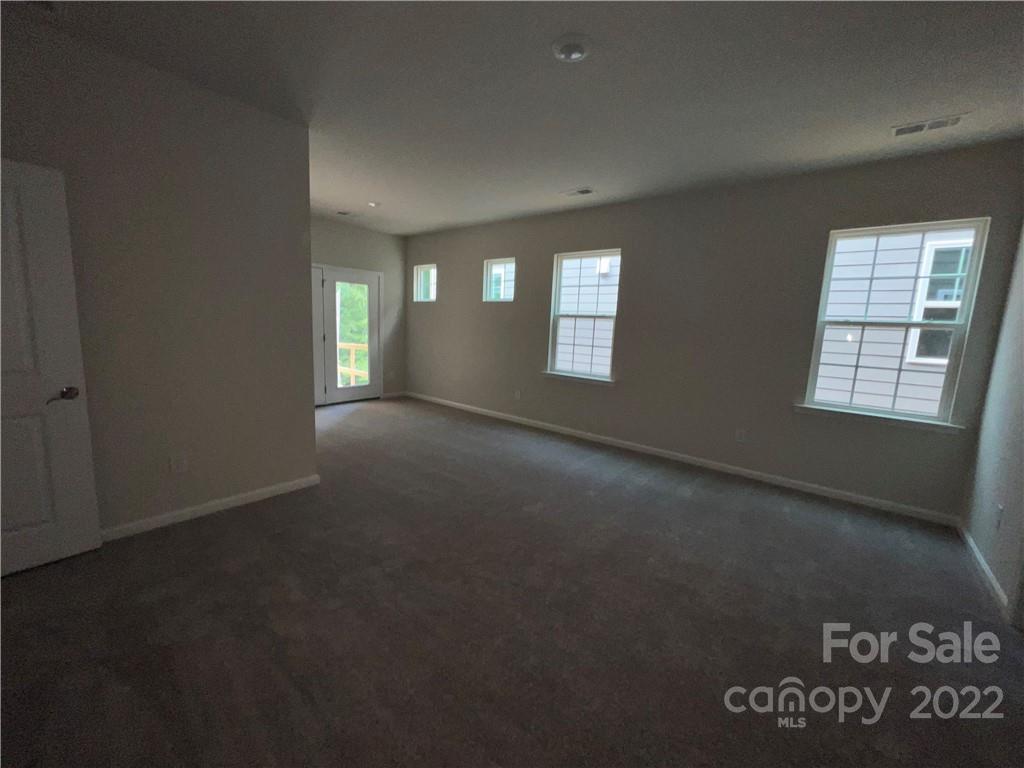 3137 Windhaven Lane, Unit 76 Tega Cay, SC 29708 - Photo 6 of 15 a view of an empty room with a window