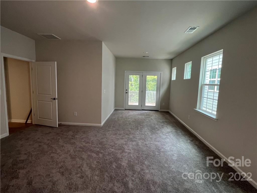3137 Windhaven Lane, Unit 76 Tega Cay, SC 29708 - Photo 7 of 15 an empty room with windows
