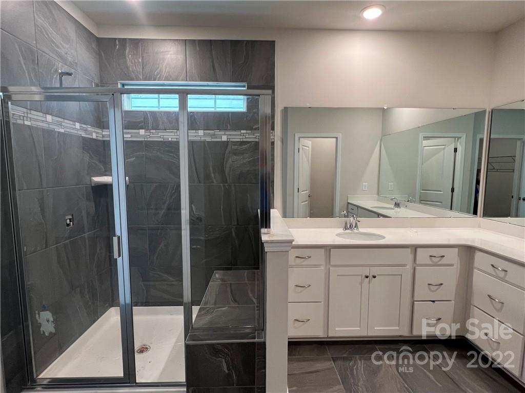 3137 Windhaven Lane, Unit 76 Tega Cay, SC 29708 - Photo 8 of 15 a bathroom with a shower sink and mirror