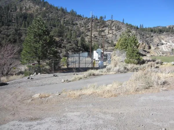 a view of a road with mountains in the background