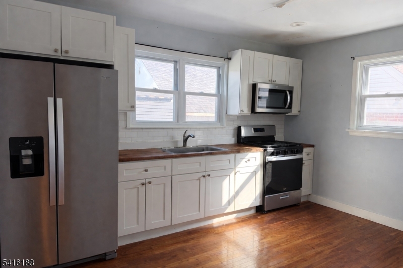 1301 Madison Hill Road Rahway, NJ 07065 - Photo 4 of 14 a kitchen with stainless steel appliances granite countertop a refrigerator sink and stove