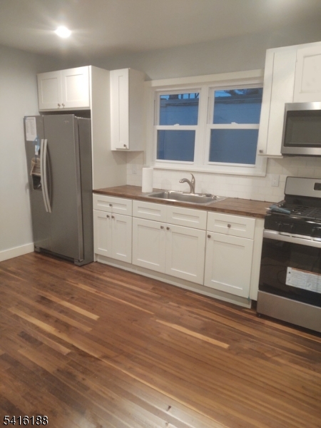 1301 Madison Hill Road Rahway, NJ 07065 - Photo 5 of 14 a kitchen with stainless steel appliances granite countertop a stove a sink and a refrigerator