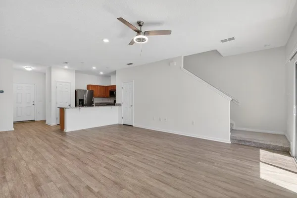 an empty room with chandelier fan