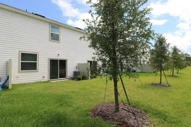 a view of house that has a window and garden