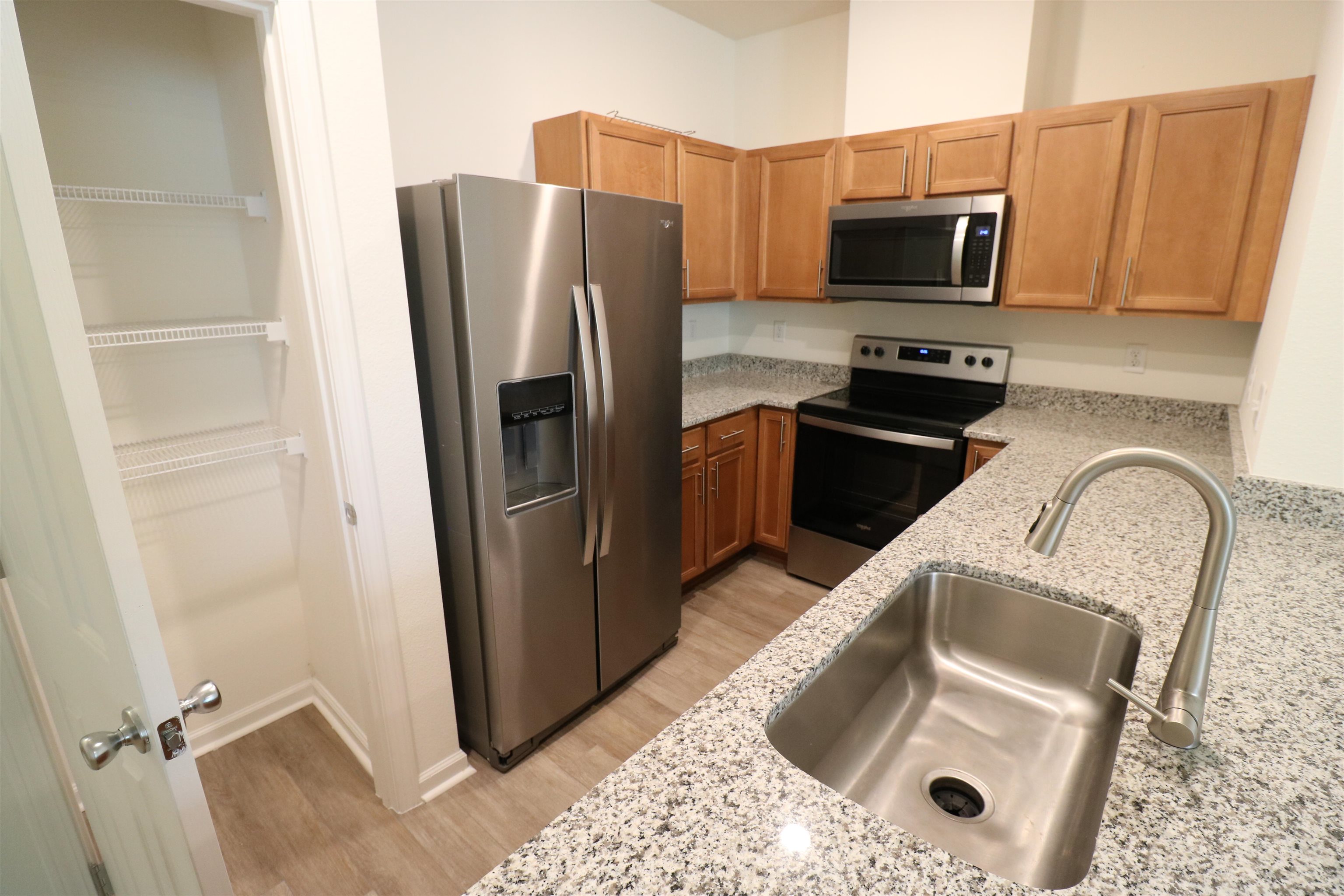 43 Mustard Hill St. Augustine, FL 32086 - Photo 4 of 25 Kitchen featuring stainless steel appliances, light granite countertops, spacious pantry and light wood finished floors.