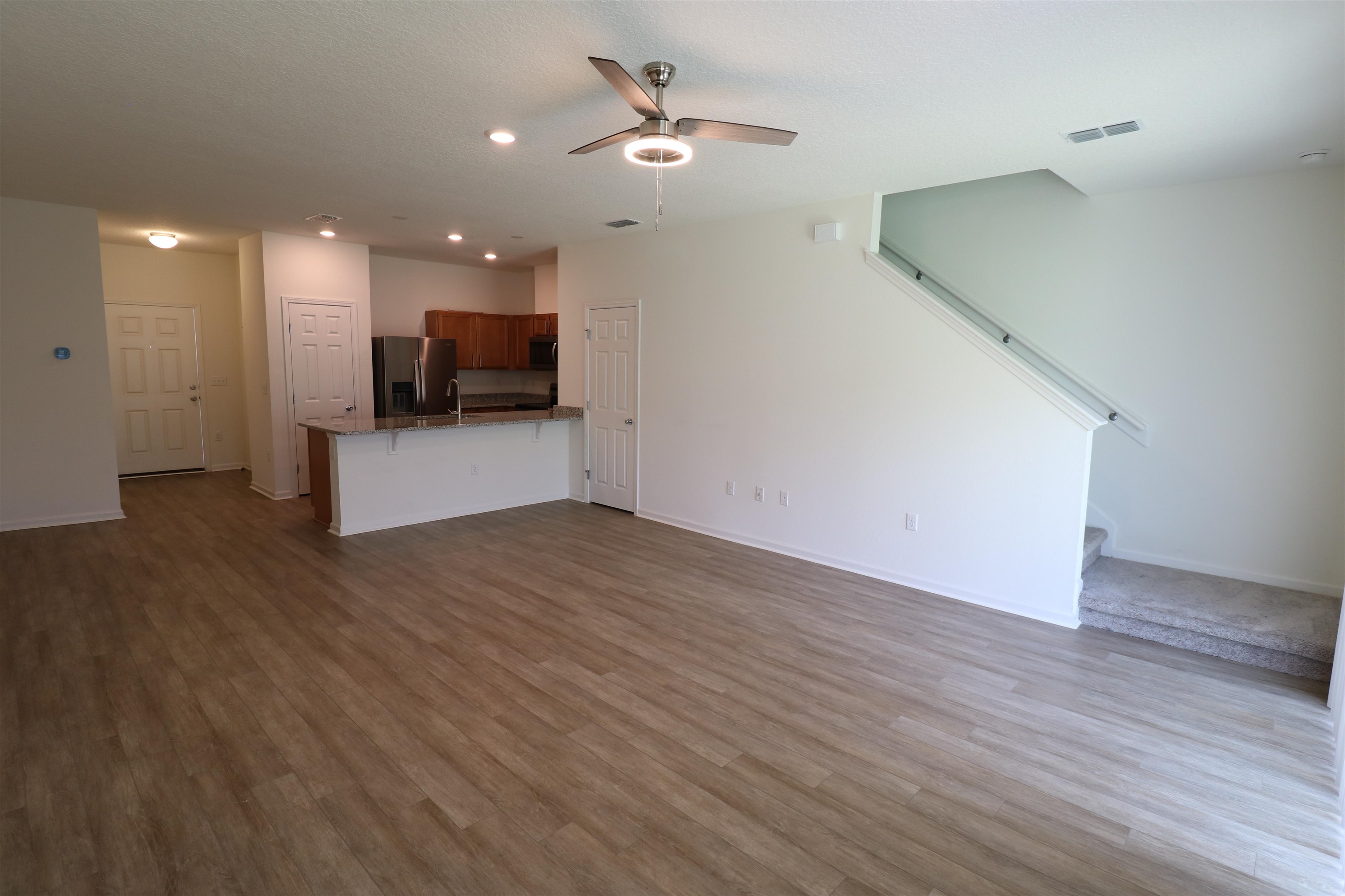 43 Mustard Hill St. Augustine, FL 32086 - Photo 5 of 25 Unfurnished living room featuring a ceiling fan, dark wood finished floors, eat-in bar and recessed lighting