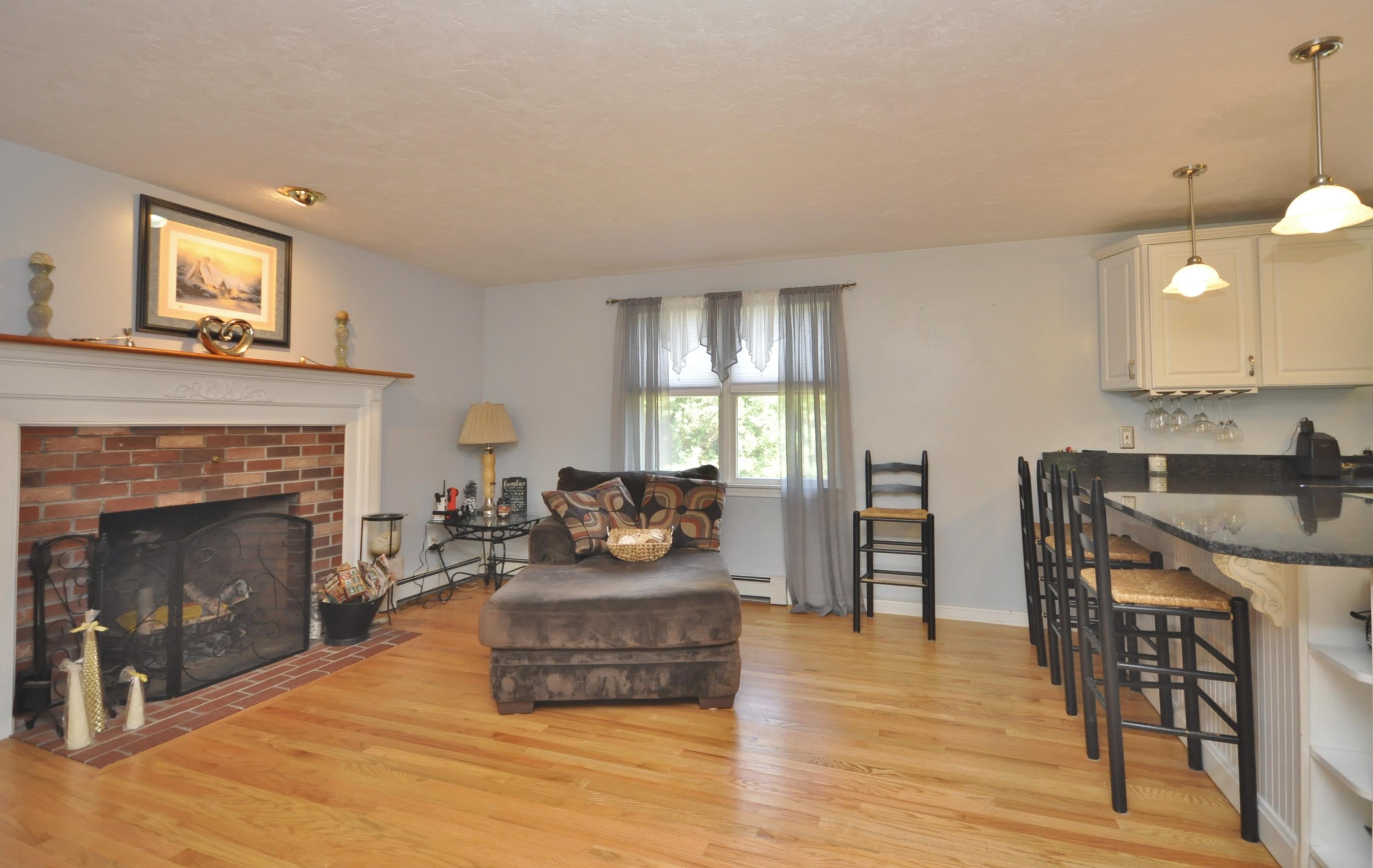 29 Swift Road Sagamore Beach, MA 02562 - Photo 11 of 34 a living room with furniture and a fireplace