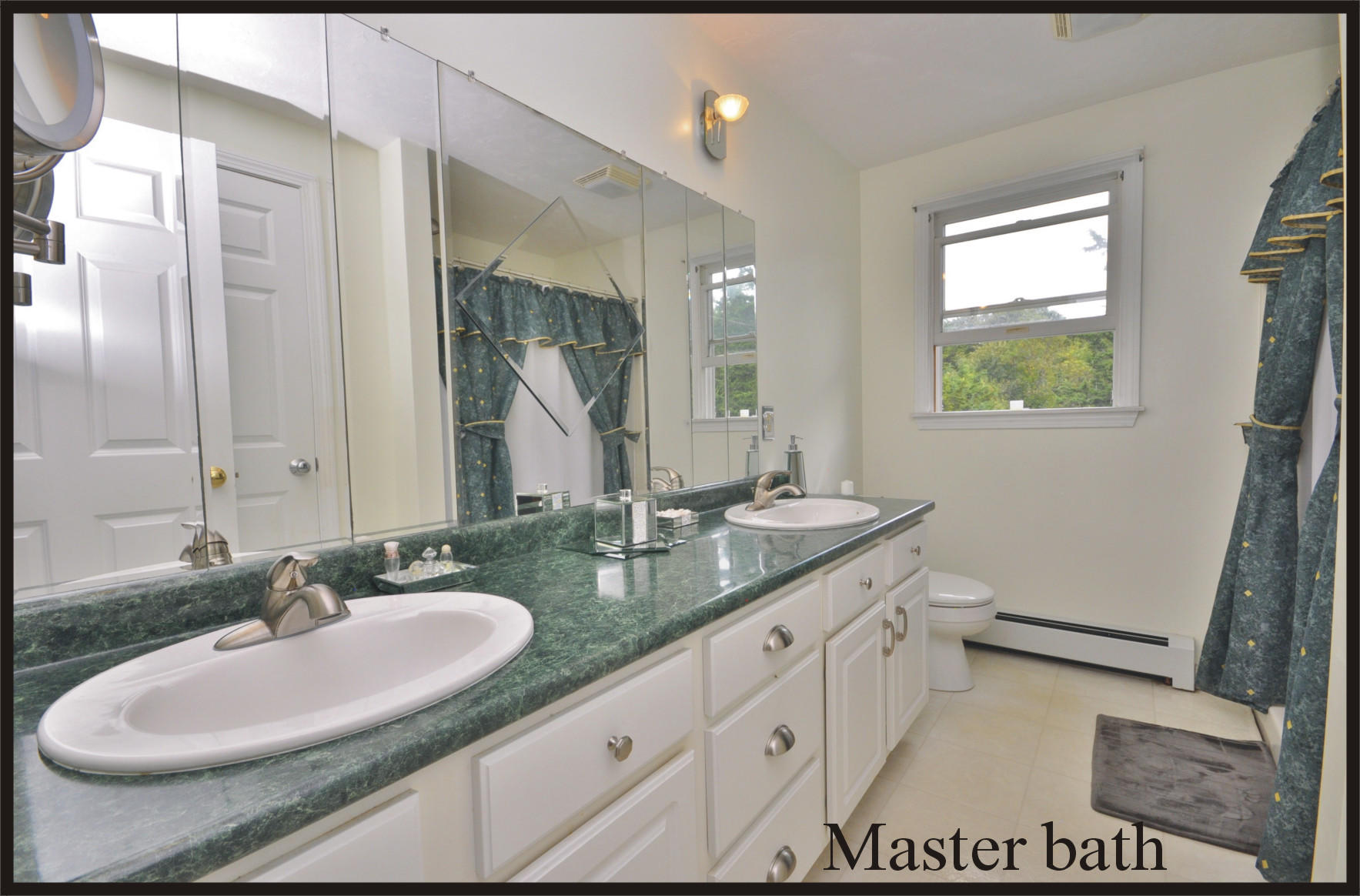 29 Swift Road Sagamore Beach, MA 02562 - Photo 18 of 34 a bathroom with a double vanity sink and a mirror