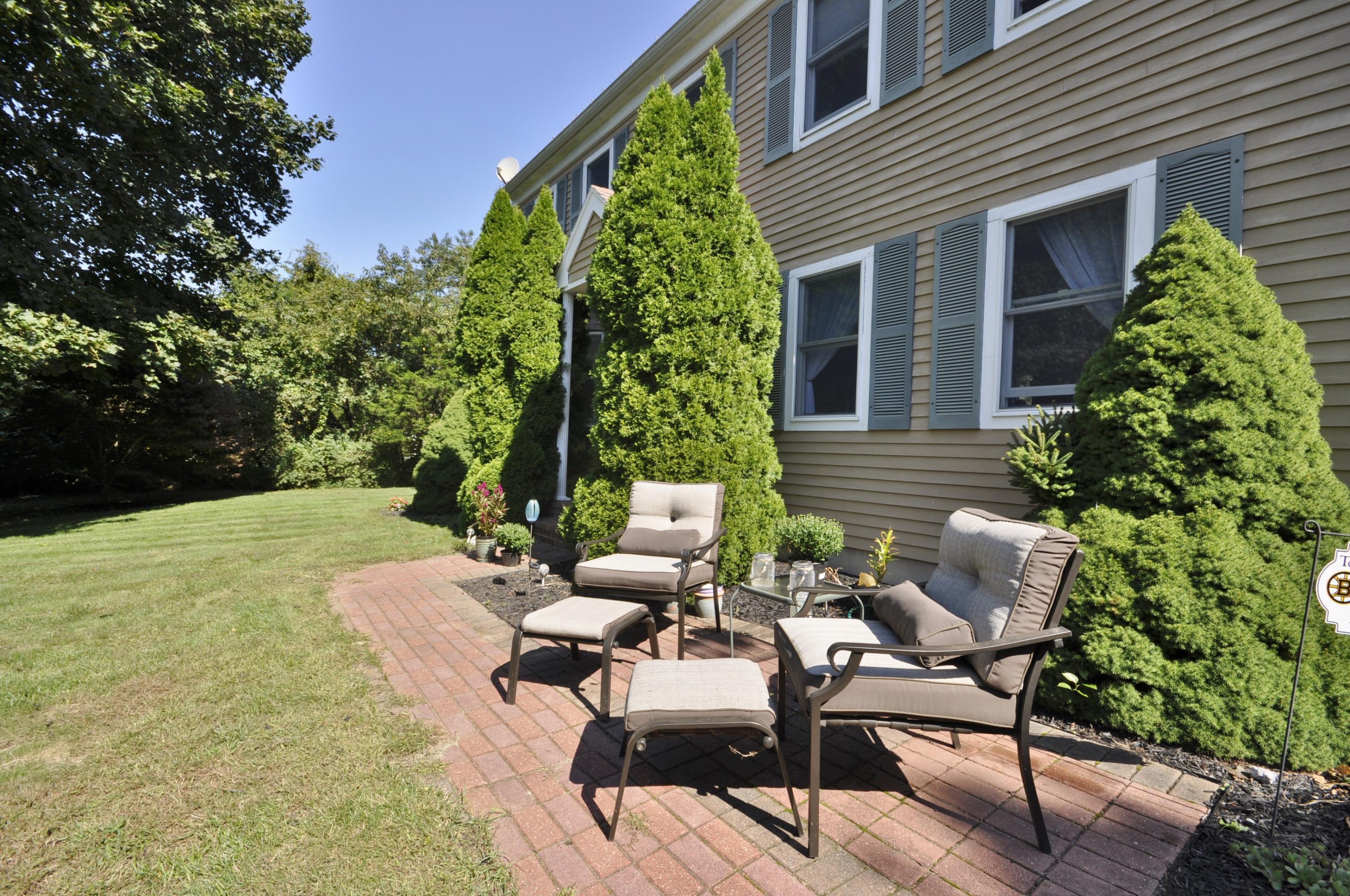 29 Swift Road Sagamore Beach, MA 02562 - Photo 2 of 34 a backyard of a house with outdoor seating