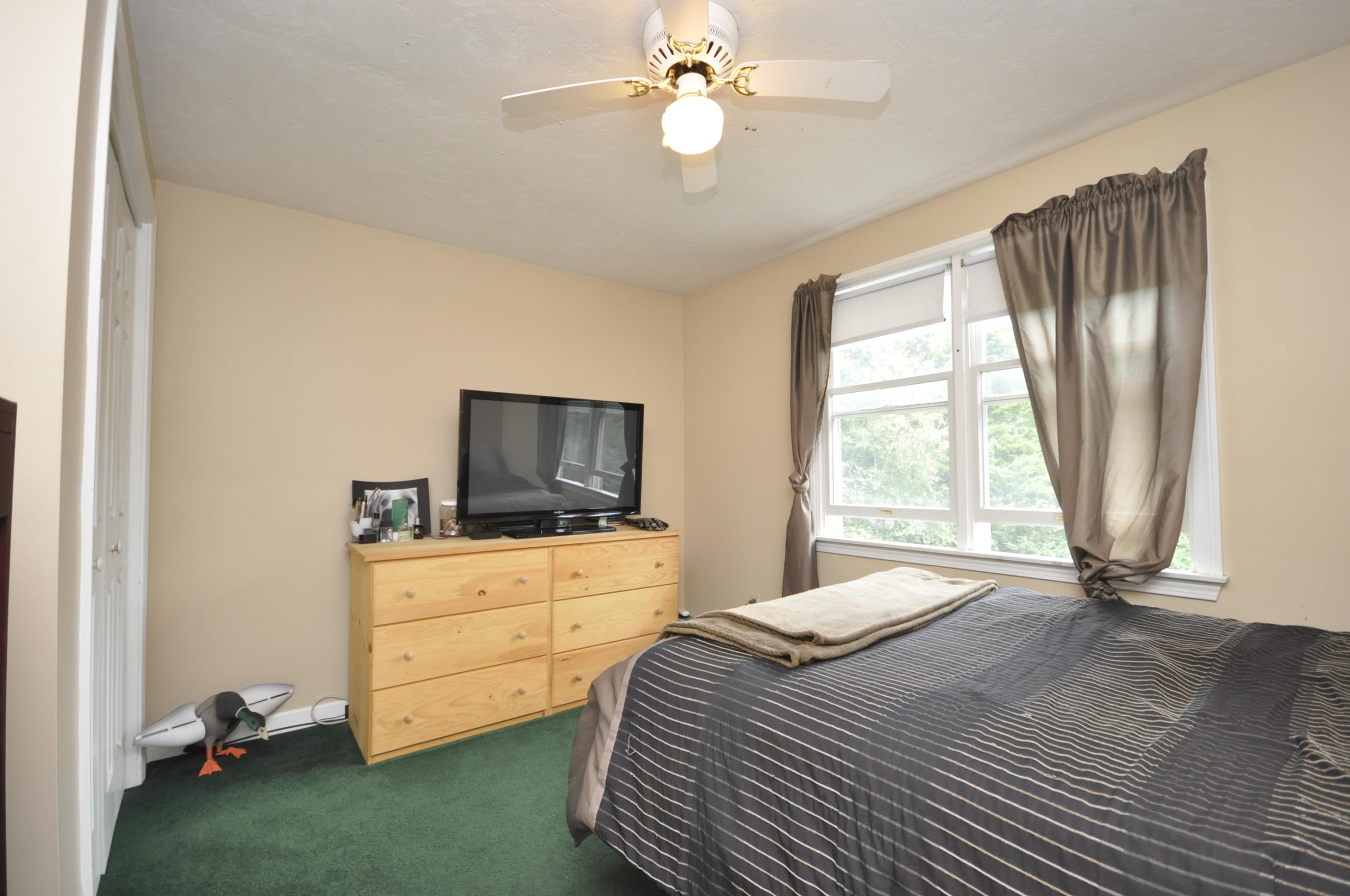 29 Swift Road Sagamore Beach, MA 02562 - Photo 23 of 34 a bedroom with a bed and a television