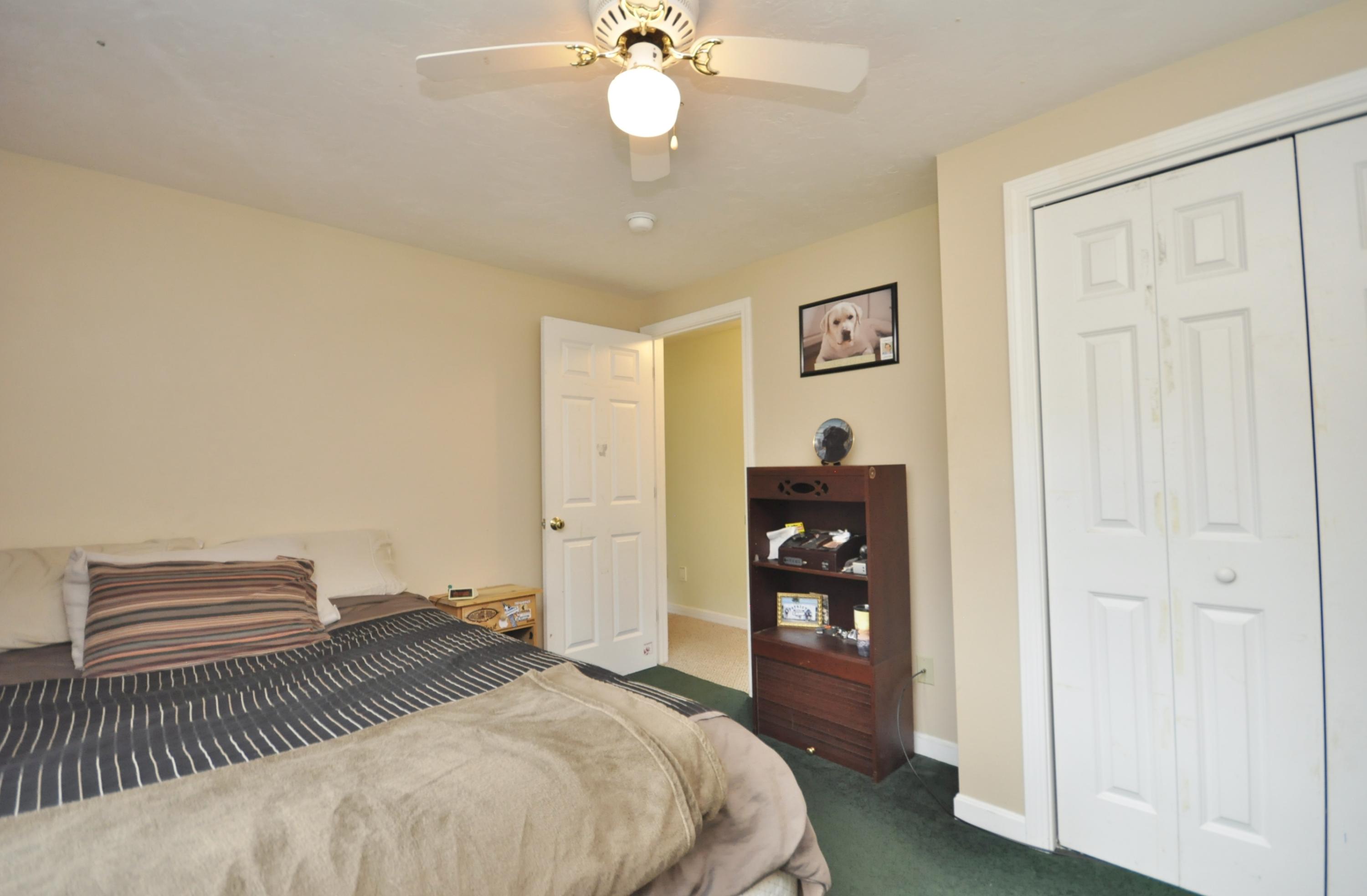 29 Swift Road Sagamore Beach, MA 02562 - Photo 24 of 34 a bedroom with a bed and a chandelier