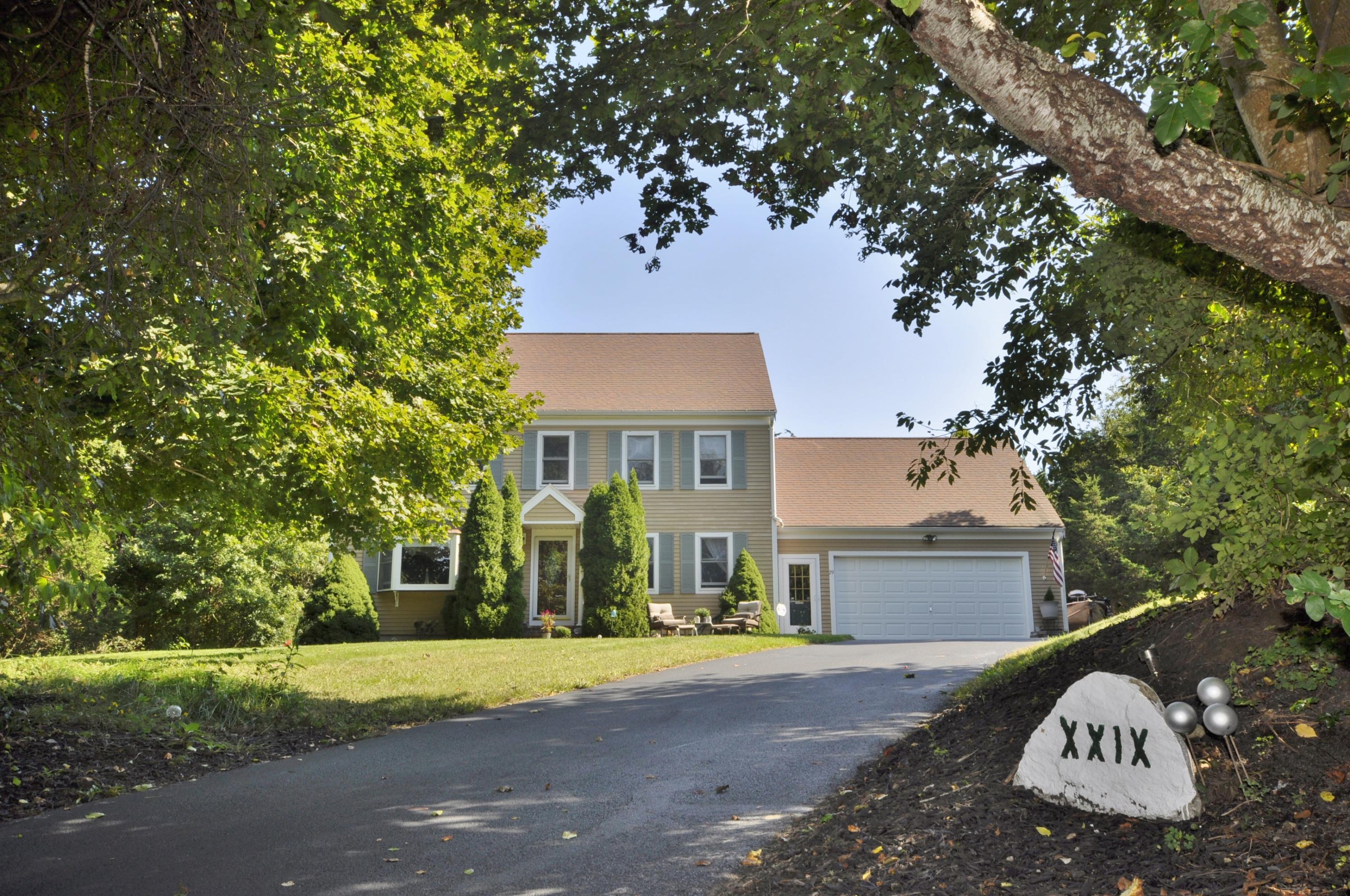 29 Swift Road Sagamore Beach, MA 02562 - Photo 27 of 34 a front view of a house with a yard and garage
