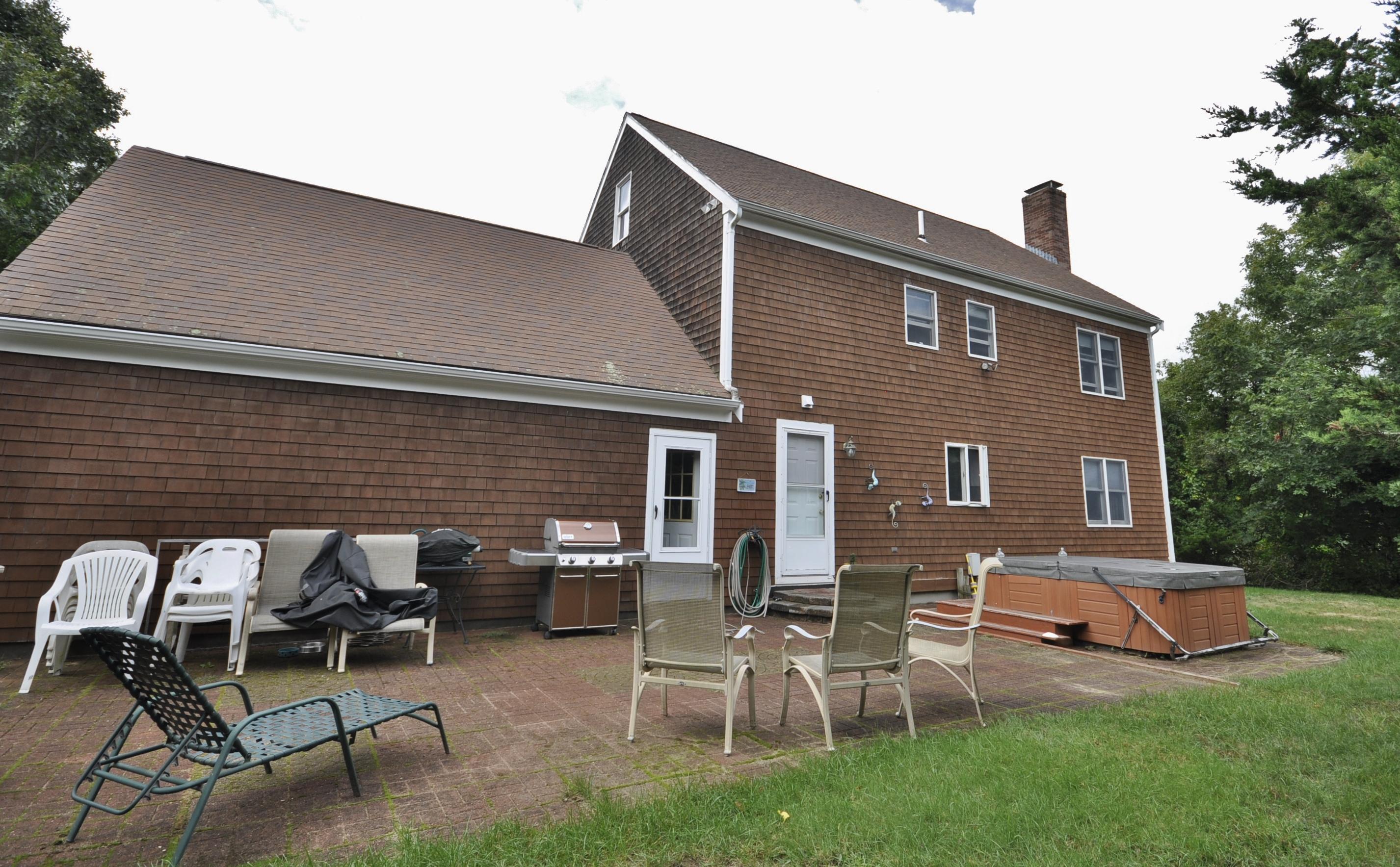 29 Swift Road Sagamore Beach, MA 02562 - Photo 30 of 34 a backyard of a house with table and chairs