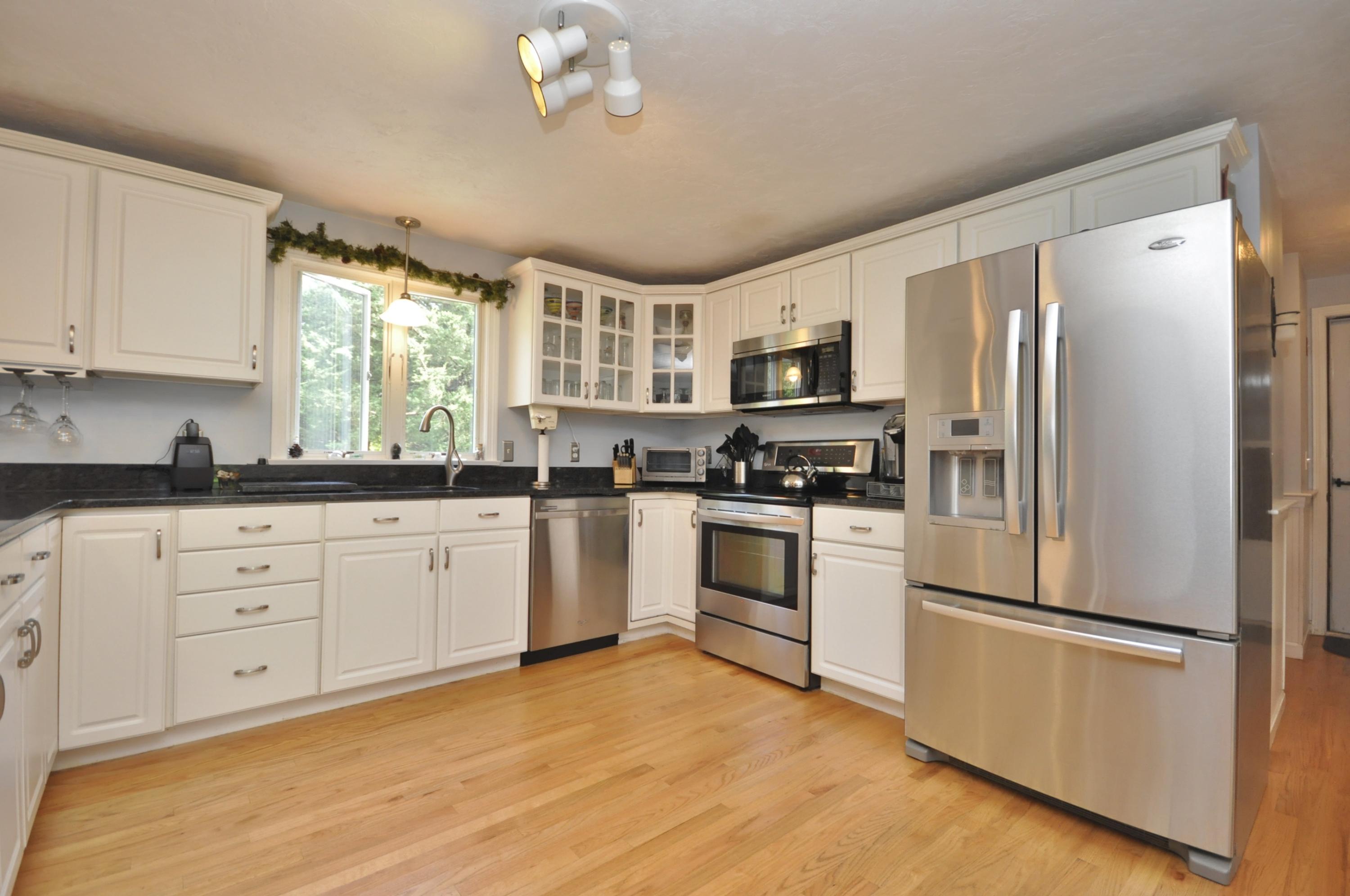 29 Swift Road Sagamore Beach, MA 02562 - Photo 4 of 34 a kitchen with cabinets stainless steel appliances and window