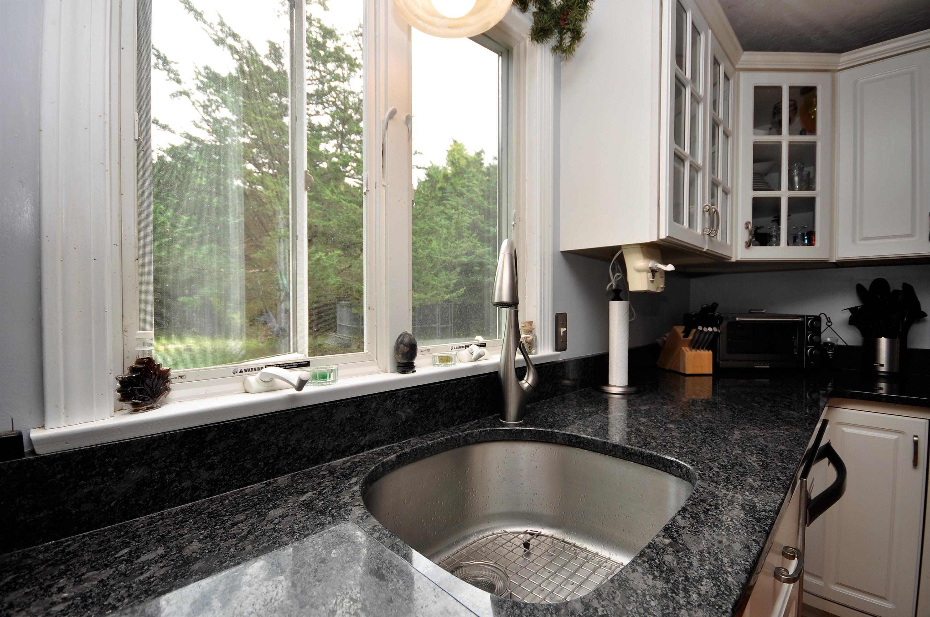 29 Swift Road Sagamore Beach, MA 02562 - Photo 6 of 34 a large kitchen with granite countertop a sink and a window