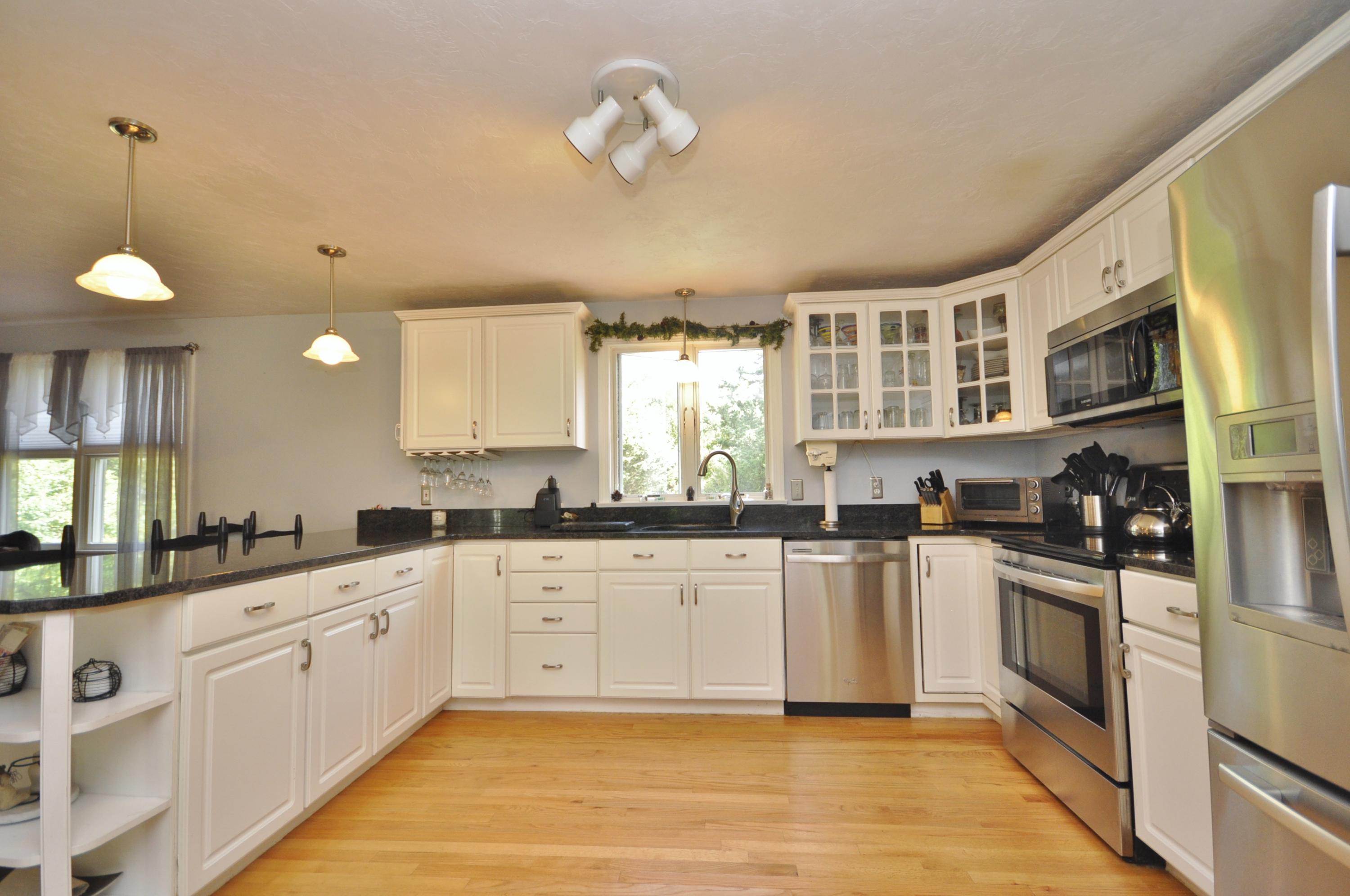 29 Swift Road Sagamore Beach, MA 02562 - Photo 7 of 34 a large kitchen with stainless steel appliances granite countertop a stove a sink dishwasher and a refrigerator