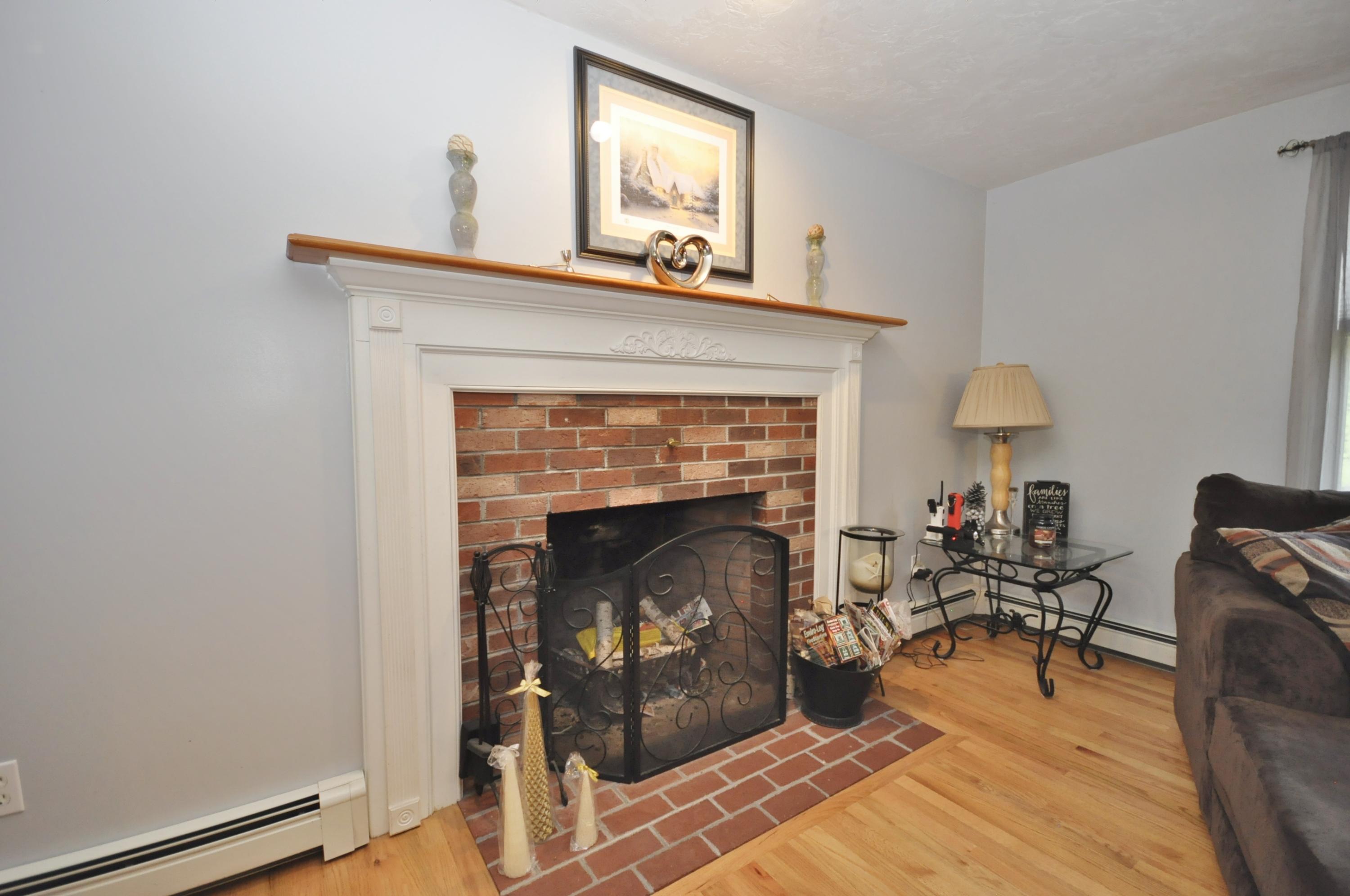 29 Swift Road Sagamore Beach, MA 02562 - Photo 10 of 34 a living room with furniture and a fireplace
