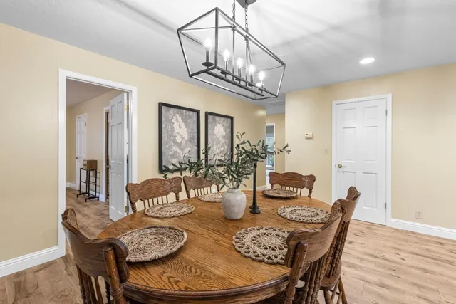 a view of a workspace with furniture and wooden floor