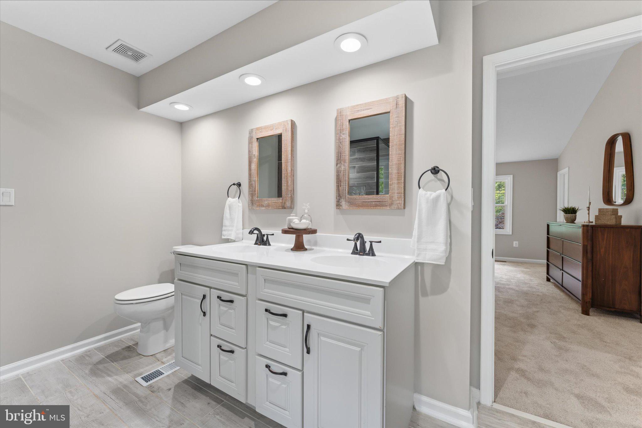 8047 Counselor Road Manassas, VA 20112 - Photo 24 of 55 Spa-inspired primary bathroom with modern updates.