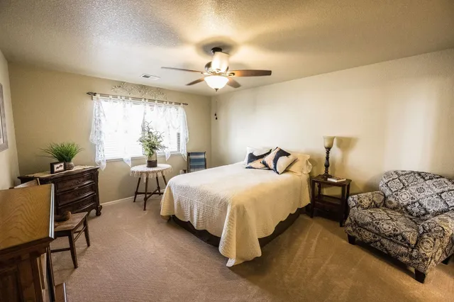 a bedroom with bed and a chandelier