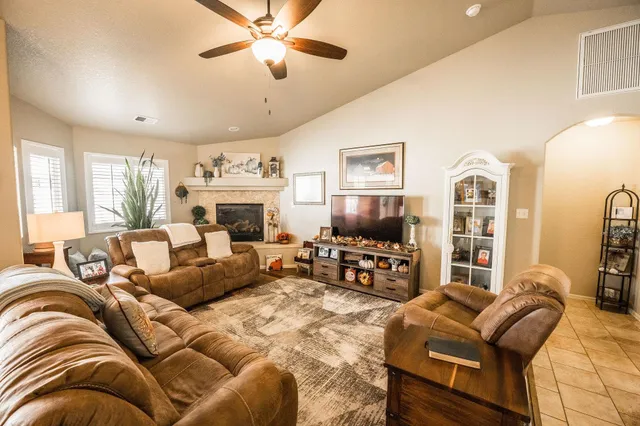 a living room with furniture fireplace and a flat screen tv