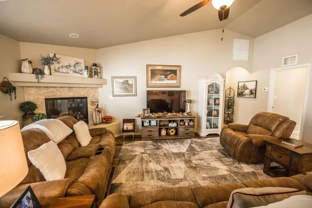 a living room with furniture fireplace and a flat screen tv