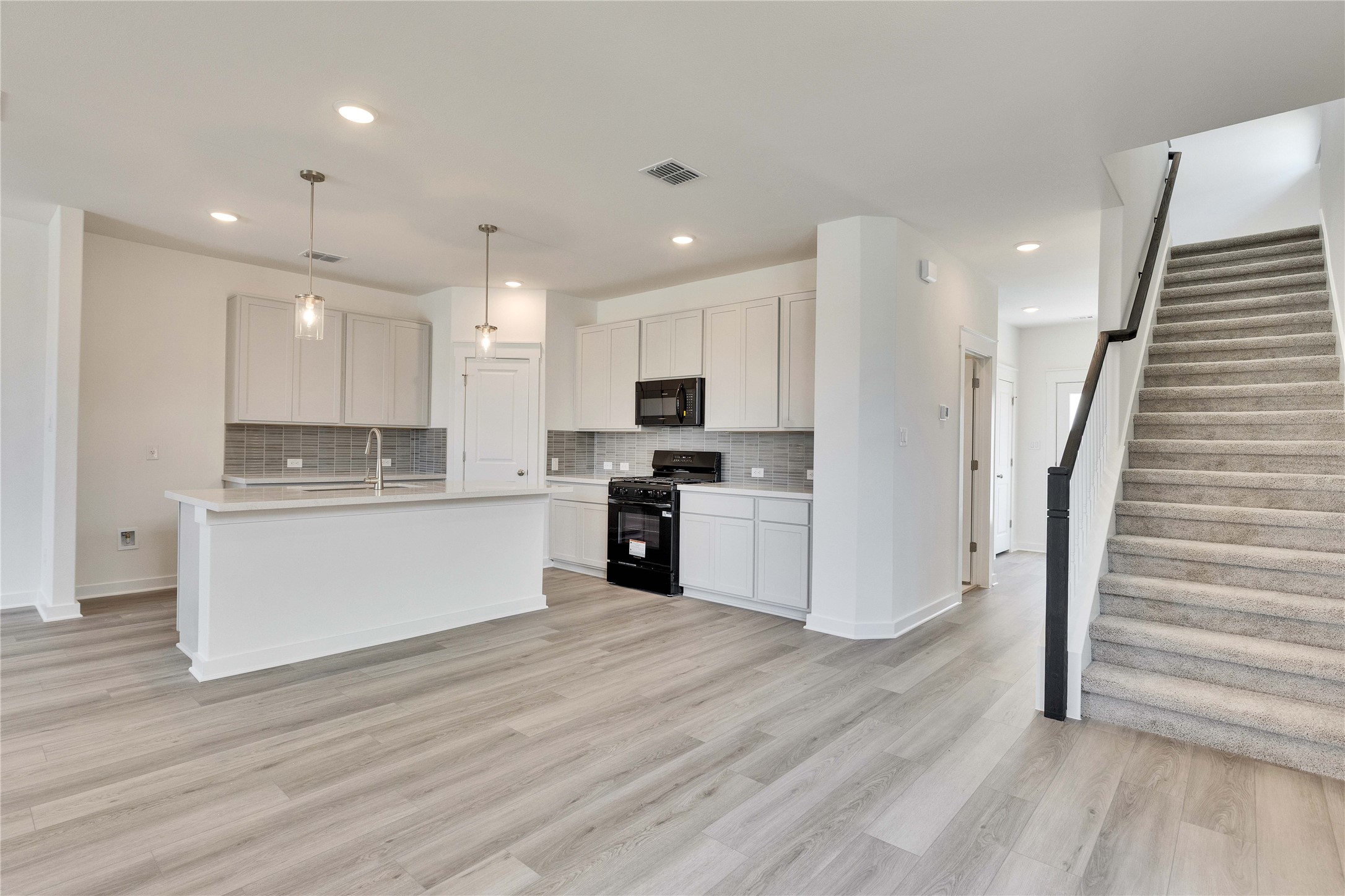 13504 Muny Parkway Elgin, TX 78621 - Photo 4 of 15 a view of kitchen with wooden floor and electronic appliances