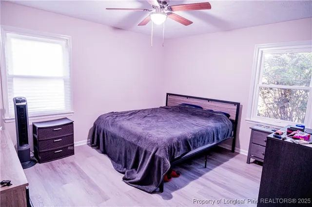 a bedroom with a bed and window