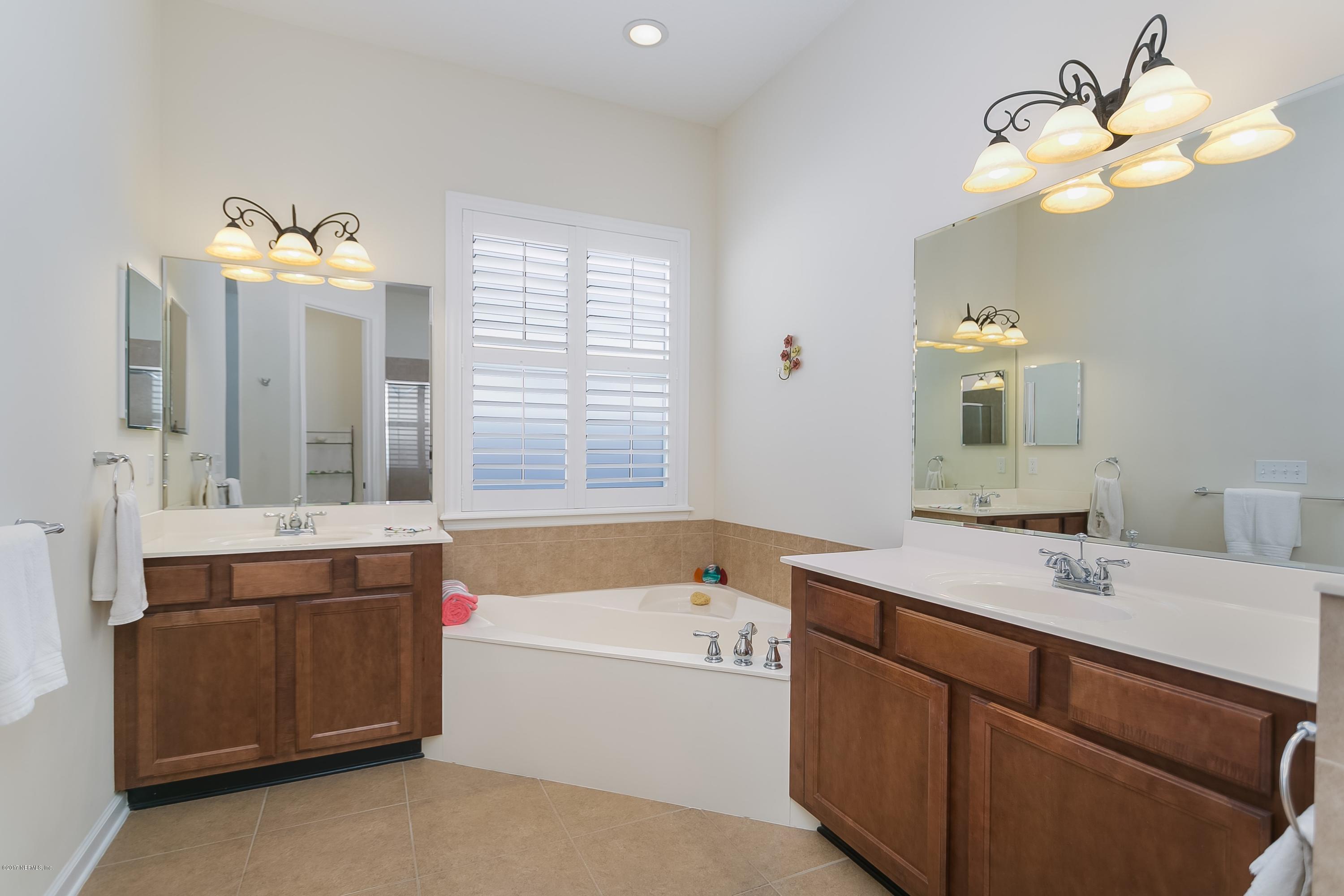 660 Porta Rosa Circle St. Augustine, FL 32092 - Photo 15 of 32 a bathroom with a tub sink and mirror
