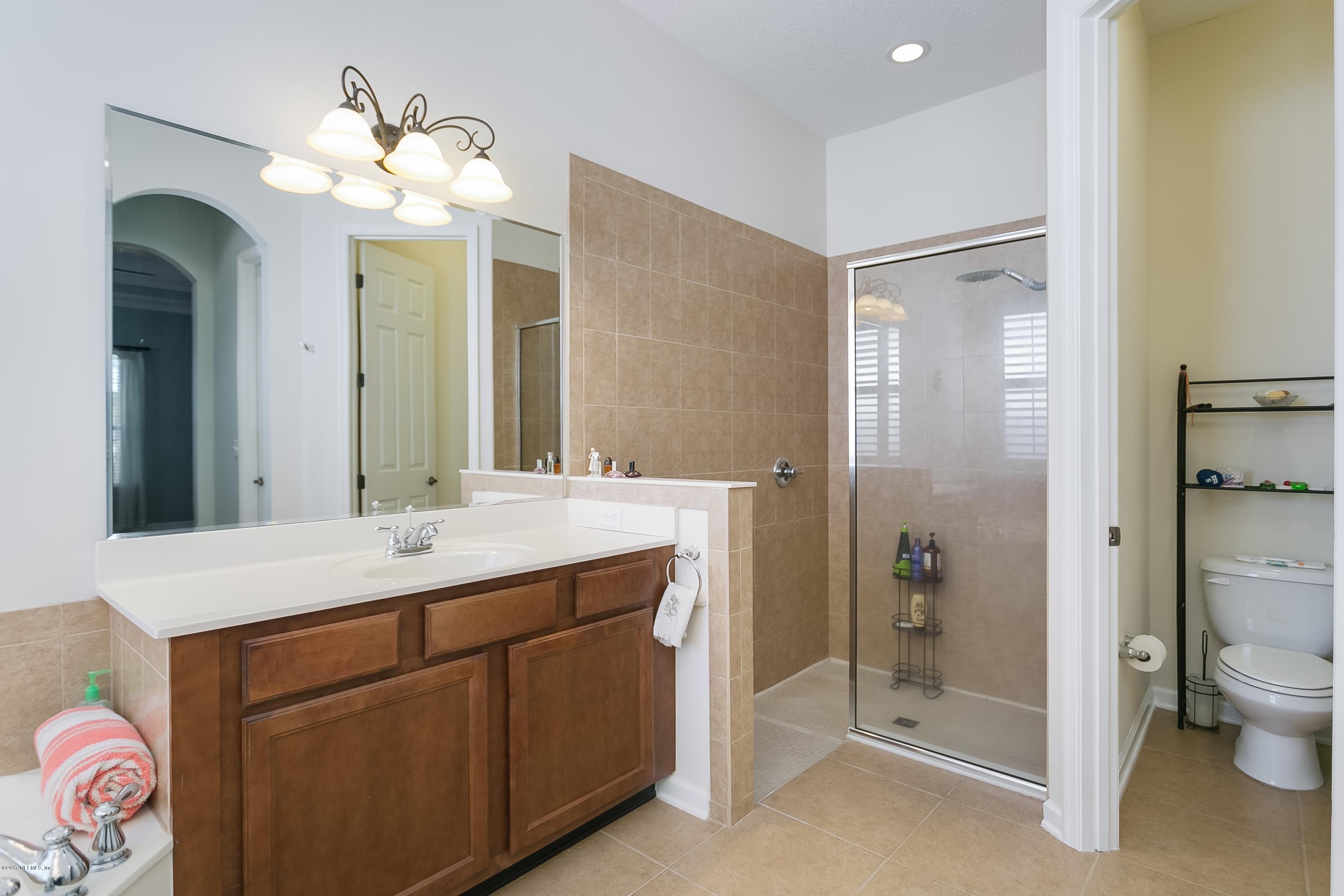 660 Porta Rosa Circle St. Augustine, FL 32092 - Photo 16 of 32 a bathroom with a double vanity sink mirror and toilet