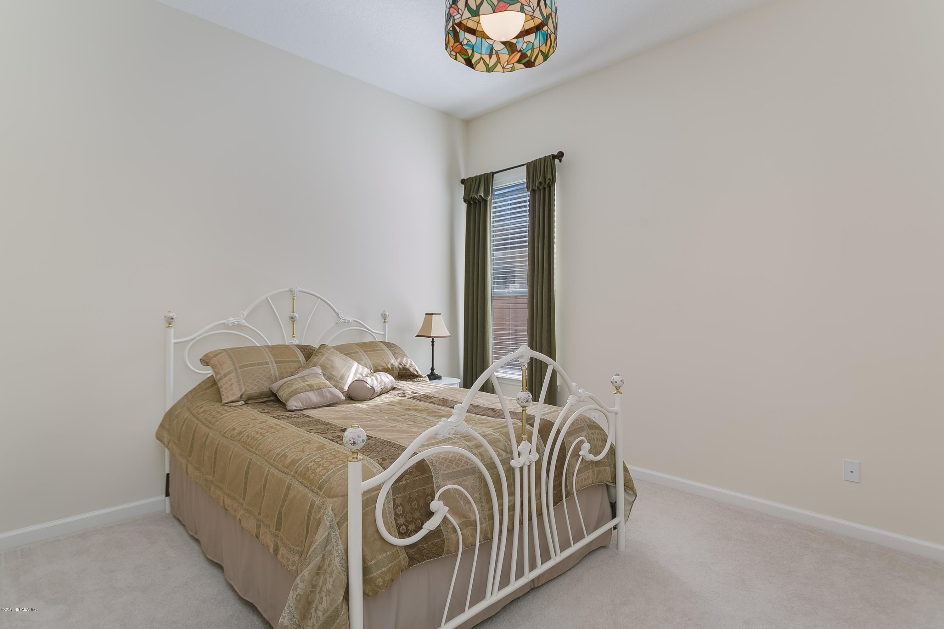 660 Porta Rosa Circle St. Augustine, FL 32092 - Photo 17 of 32 a bedroom with a bed and a window