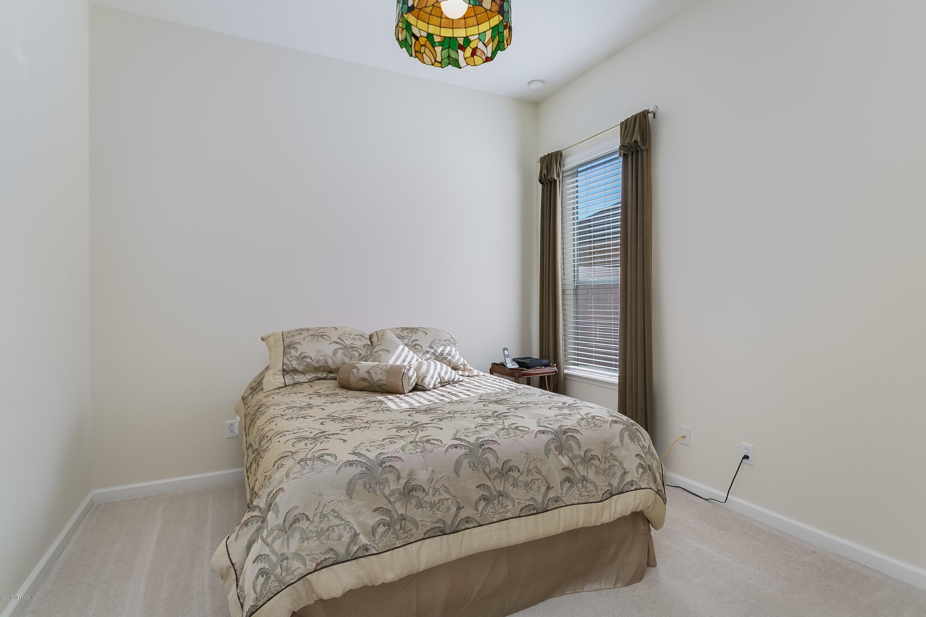 660 Porta Rosa Circle St. Augustine, FL 32092 - Photo 21 of 32 a bedroom with a bed and a window