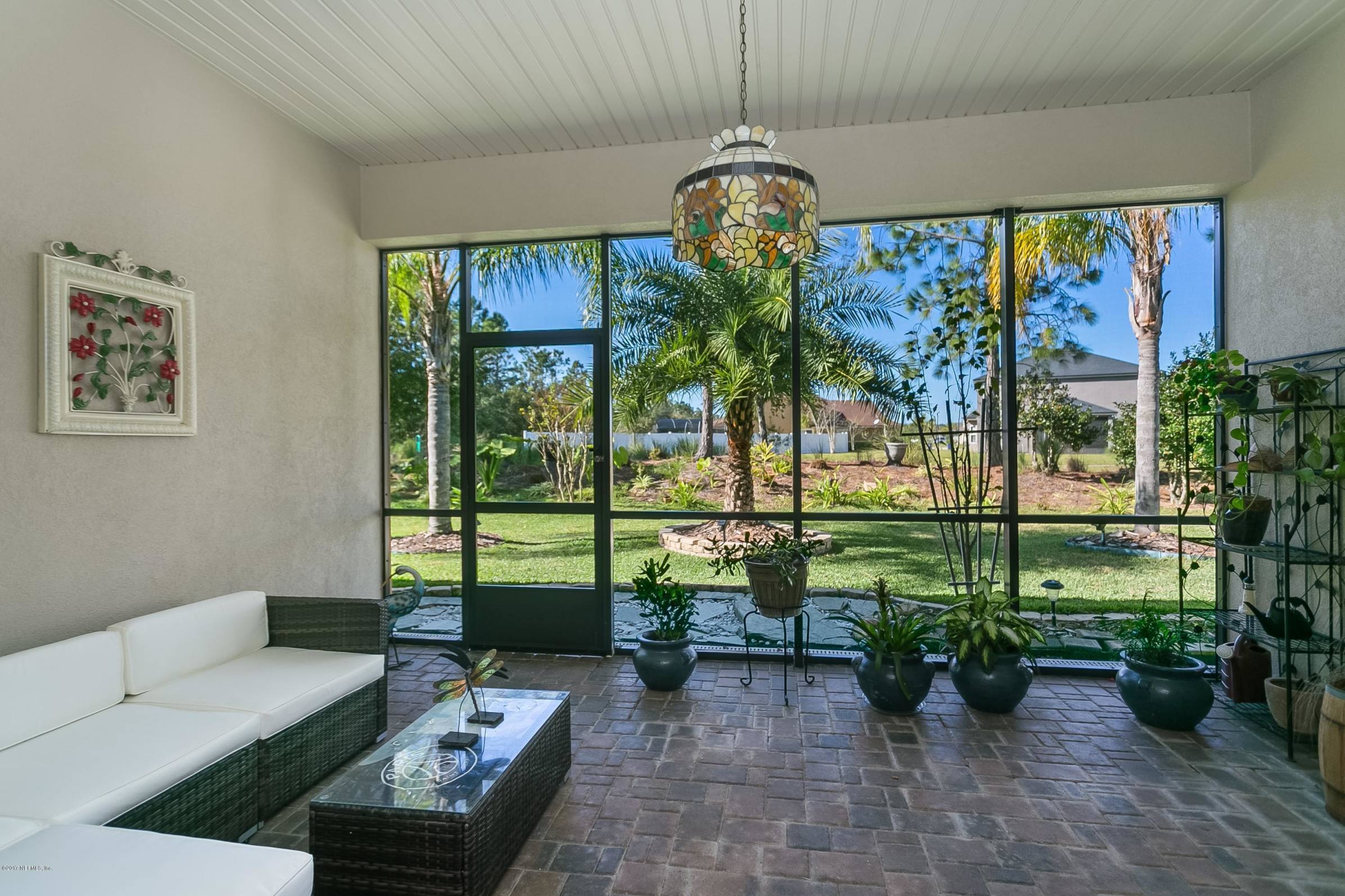 660 Porta Rosa Circle St. Augustine, FL 32092 - Photo 23 of 32 a living room with patio area and a floor to ceiling window