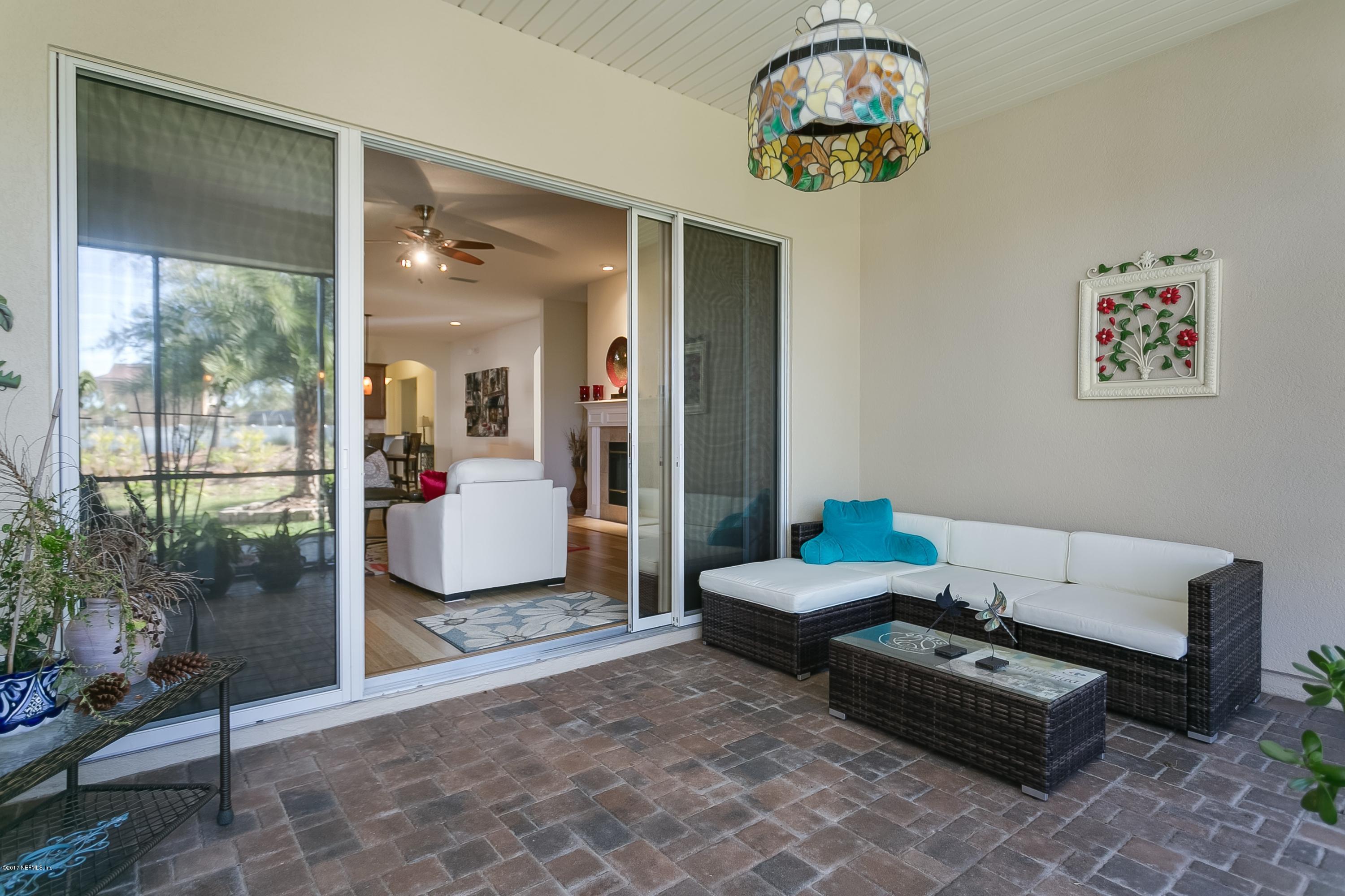 660 Porta Rosa Circle St. Augustine, FL 32092 - Photo 24 of 32 a living room with furniture and a floor to ceiling window