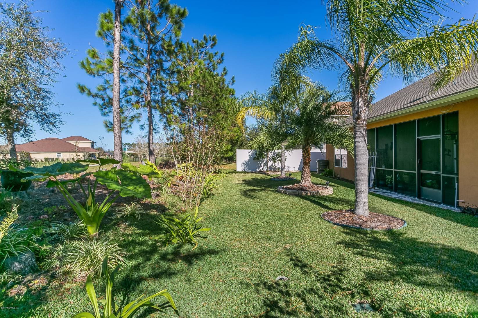 660 Porta Rosa Circle St. Augustine, FL 32092 - Photo 26 of 32 a view of a garden with a tree