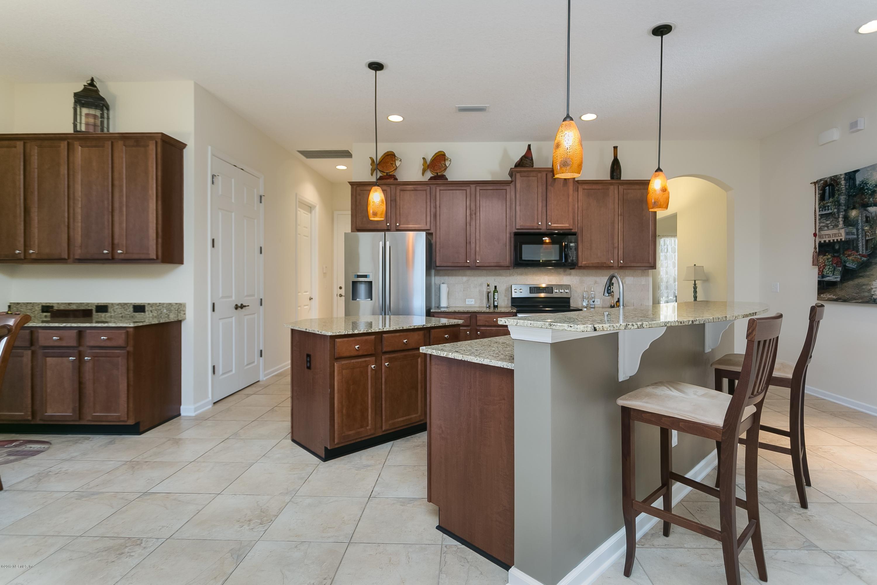 660 Porta Rosa Circle St. Augustine, FL 32092 - Photo 6 of 32 a kitchen with stainless steel appliances granite countertop a stove a sink and a refrigerator