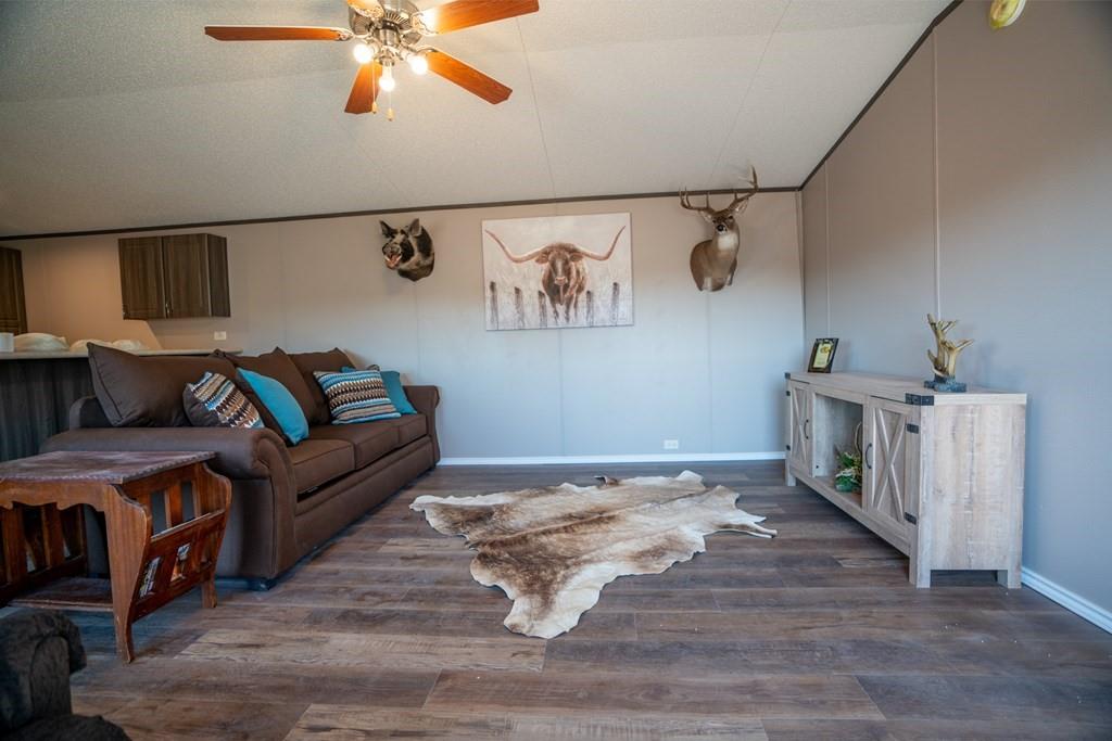 0 Poverty Canyon Road Robert Lee, TX 76945 - Photo 14 of 39 Living area with a ceiling fan, vaulted ceiling, and wood finished floors