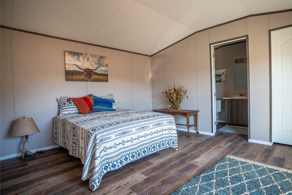 0 Poverty Canyon Road Robert Lee, TX 76945 - Photo 15 of 39 Bedroom featuring lofted ceiling, wood finished floors, and crown molding