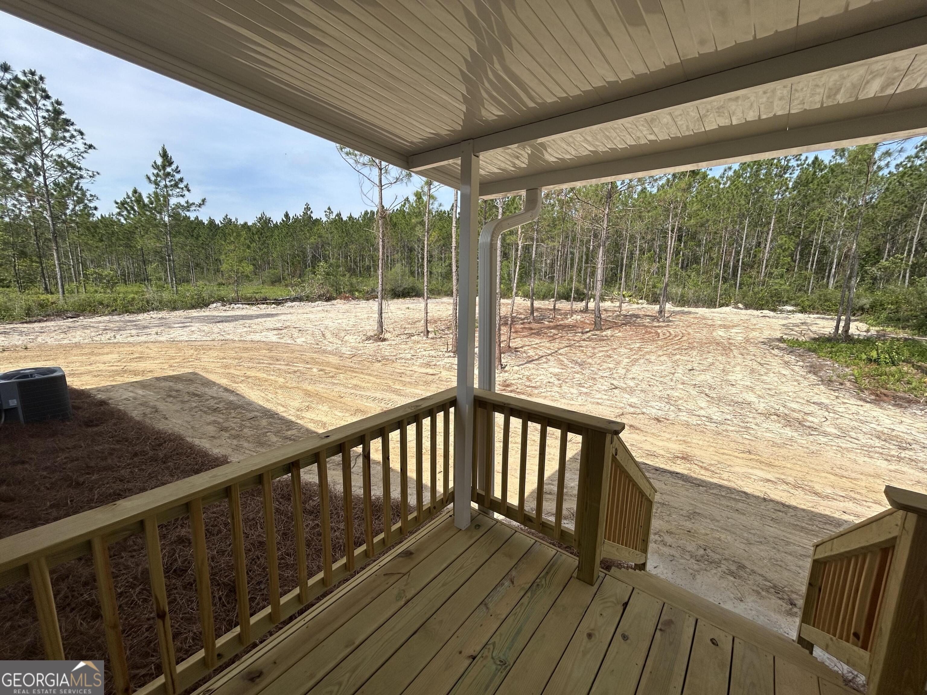 640 Elmer Thrift Road Waycross, GA 31503 - Photo 6 of 23 a view of roof deck with wooden floor and fence