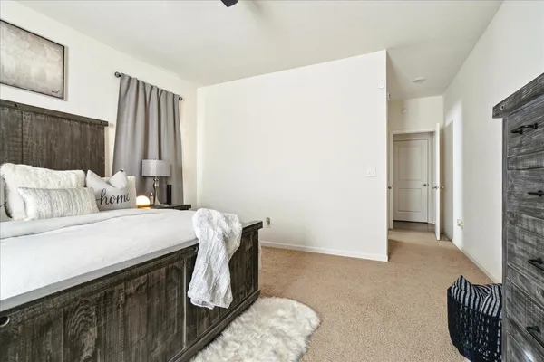 a bedroom with a bed and a couch