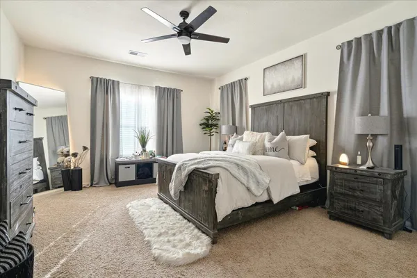 a bedroom with a bed dresser and a window