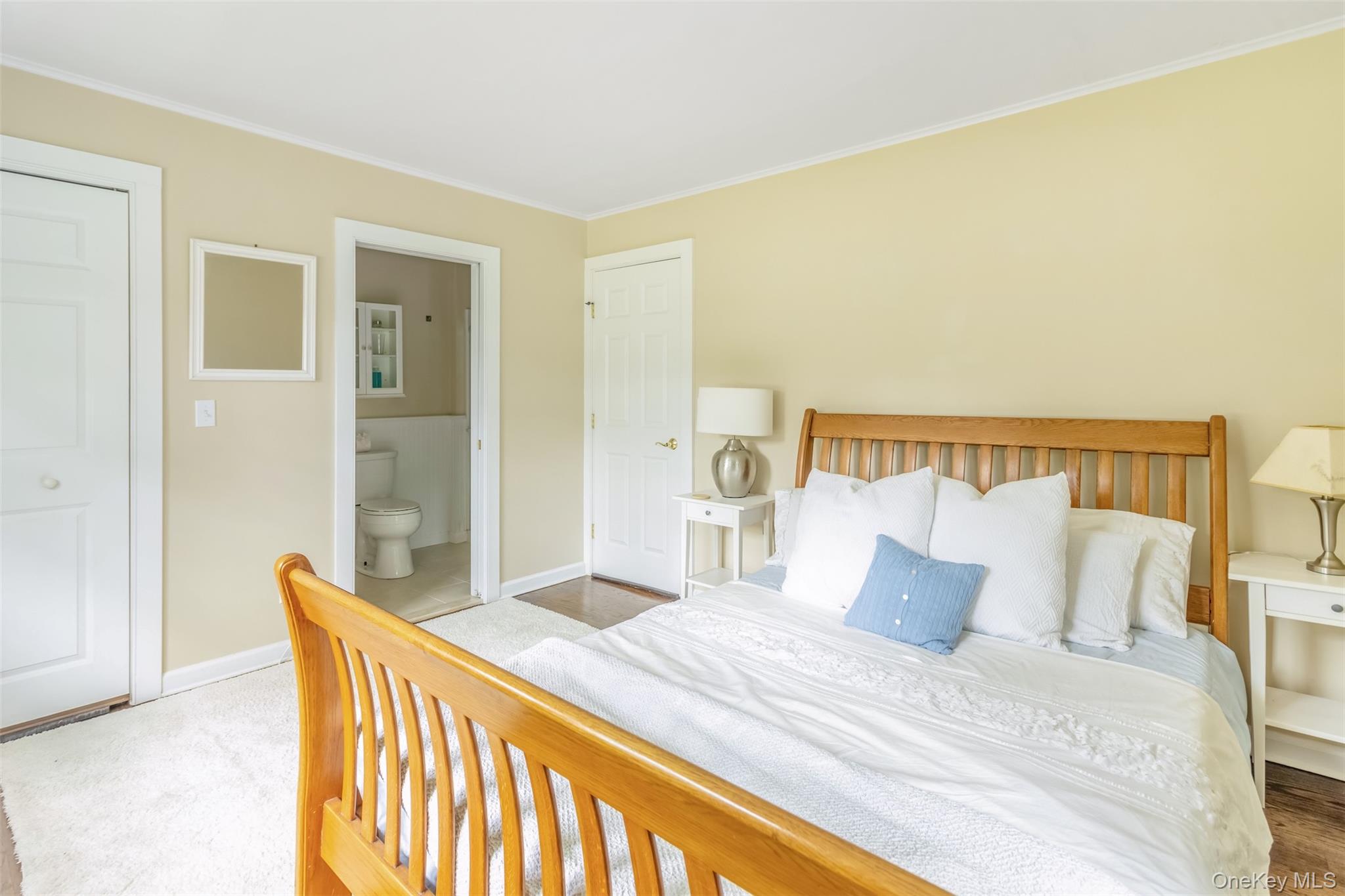 315 Wicks Road New Suffolk, NY 11956 - Photo 19 of 28 a bedroom with a bed and wooden floor