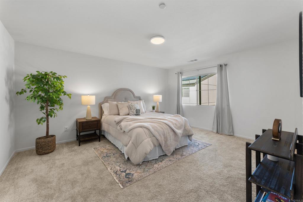 212 Perennial Place Fallbrook, CA 92028 - Photo 19 of 39 a bedroom with a bed and a potted plant