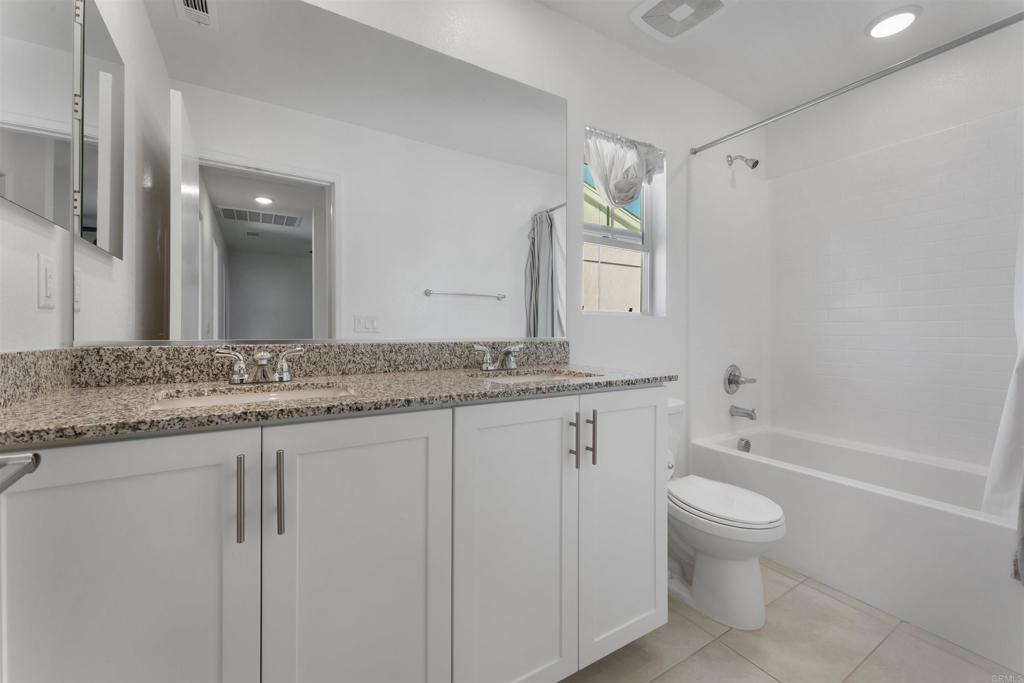 212 Perennial Place Fallbrook, CA 92028 - Photo 22 of 39 a bathroom with a granite countertop sink a toilet and bathtub