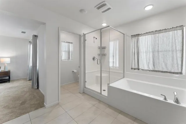 a spacious bathroom with a bathtub and a shower