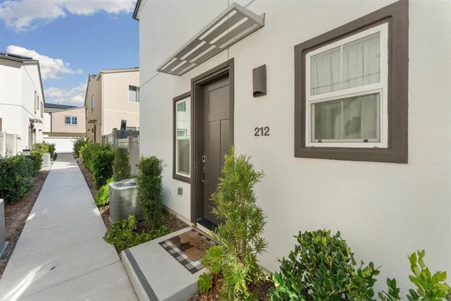 a view of a front door and potted plants