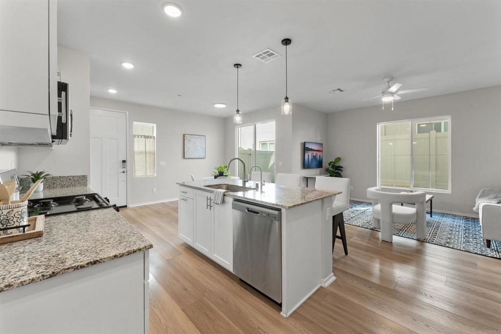 212 Perennial Place Fallbrook, CA 92028 - Photo 4 of 39 a kitchen with stainless steel appliances granite countertop a stove and chairs