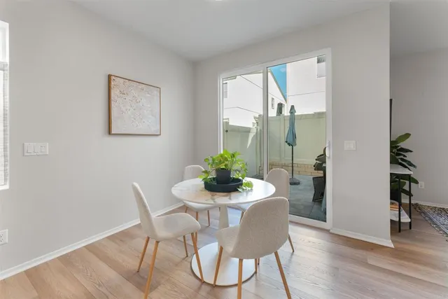 a dining room with furniture and wooden floor